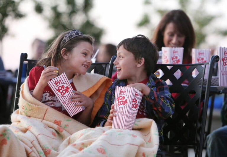 Children Watching Movie on Grand Plaza with Popcorn