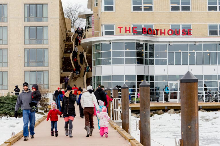 Family Walking on Edgewater Pier During Winter, Boathouse in Background